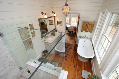 Inspiration for a mid-sized farmhouse master stone tile dark wood floor bathroom remodel in Baltimore with a two-piece toilet, beige walls, an undermount sink, marble countertops, raised-panel cabinets and gray cabinets
