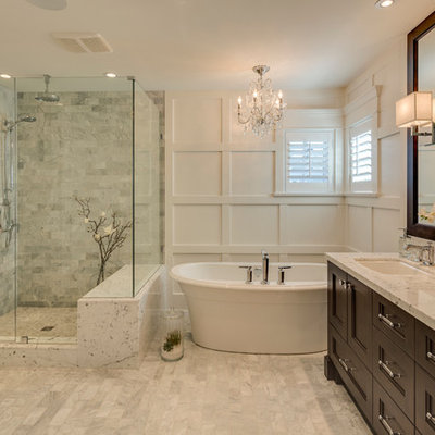 Inspiration for a mid-sized timeless master gray tile and ceramic tile porcelain tile bathroom remodel in Vancouver with an undermount sink, recessed-panel cabinets, dark wood cabinets, granite countertops and white walls