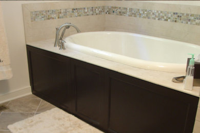 Large transitional master beige tile and ceramic tile ceramic tile bathroom photo in Richmond with raised-panel cabinets, dark wood cabinets, a one-piece toilet, an undermount sink and granite countertops