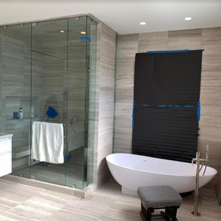 This is an example of a mid-sized modern bathroom in Los Angeles with beige walls, bamboo floors, a drop-in sink, solid surface benchtops and beige benchtops.