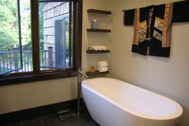 Exempel på ett mellanstort modernt en-suite badrum, med ett fristående badkar, en hörndusch, grå kakel, porslinskakel och beige väggar