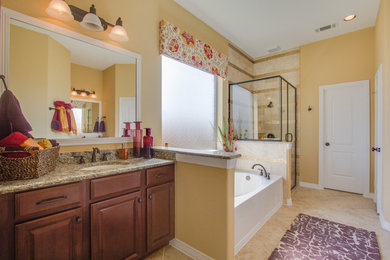 Bathroom - traditional master beige tile and ceramic tile ceramic tile and beige floor bathroom idea in Houston with shaker cabinets, brown cabinets, brown countertops, granite countertops, yellow walls, an undermount sink and a hinged shower door