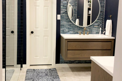 Example of a mid-sized trendy master blue tile and glass tile porcelain tile and gray floor bathroom design in Dallas with distressed cabinets, blue walls and white countertops