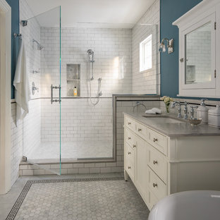Photo of a mid-sized victorian master bathroom in Boston with recessed-panel cabinets, white cabinets, an alcove shower, white tile, subway tile, blue walls, an undermount sink, grey floor, a hinged shower door, a claw-foot tub, marble floors, engineered quartz benchtops and grey benchtops.