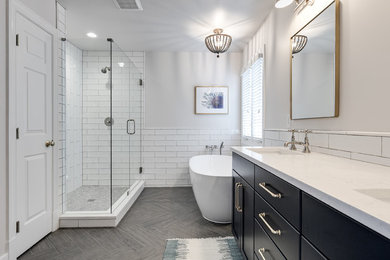 Bathroom - large contemporary master white tile and subway tile porcelain tile and gray floor bathroom idea in Richmond with recessed-panel cabinets, blue cabinets, a two-piece toilet, white walls, an undermount sink, quartz countertops, a hinged shower door and white countertops