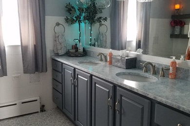Photo of a small shabby-chic style ensuite bathroom in Chicago with freestanding cabinets, blue cabinets, a built-in bath, a shower/bath combination, a one-piece toilet, white tiles, ceramic tiles, white walls, ceramic flooring, a submerged sink, granite worktops, multi-coloured floors, a shower curtain and white worktops.