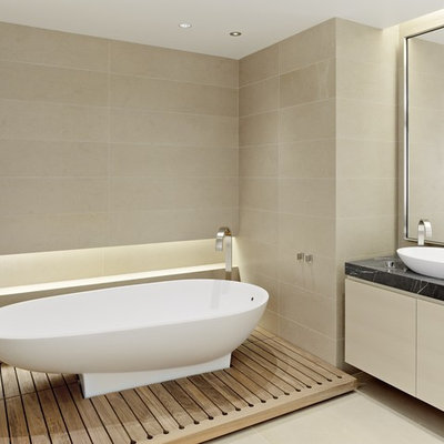 Example of a trendy limestone tile freestanding bathtub design in San Francisco with a vessel sink