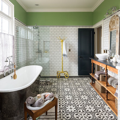 Country master white tile and subway tile cement tile floor and multicolored floor bathroom photo in Atlanta with furniture-like cabinets, medium tone wood cabinets, gray walls, a vessel sink and black countertops