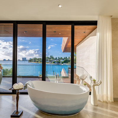 Freestanding bathtub - contemporary brown tile beige floor freestanding bathtub idea in Miami with flat-panel cabinets and beige cabinets
