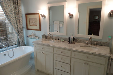 Example of a small classic master marble floor freestanding bathtub design in Dallas with recessed-panel cabinets, white cabinets, a one-piece toilet, blue walls, an undermount sink and quartzite countertops