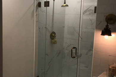 Example of a small trendy white tile and marble tile marble floor, white floor and single-sink alcove shower design in Portland with shaker cabinets, white cabinets, a one-piece toilet, beige walls, an undermount sink, quartzite countertops, a hinged shower door, white countertops, a niche and a freestanding vanity