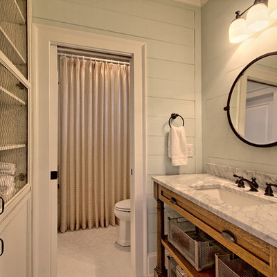 Inspiration for a mid-sized country 3/4 mosaic tile floor tub/shower combo remodel in Atlanta with recessed-panel cabinets, distressed cabinets, a two-piece toilet, gray walls and marble countertops