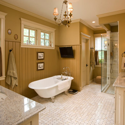 Inspiration for a mid-sized timeless master ceramic tile bathroom remodel in Minneapolis with an undermount sink, raised-panel cabinets, distressed cabinets, a one-piece toilet, green walls and granite countertops