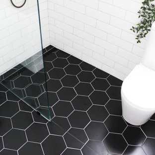 Inspiration for a small modern kids' white tile and ceramic tile porcelain tile, black floor, single-sink and brick wall bathroom remodel in Perth with shaker cabinets, white cabinets, a one-piece toilet, white walls, a vessel sink, wood countertops, beige countertops and a floating vanity