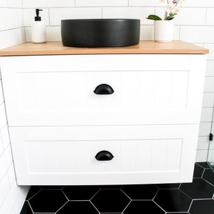 Small minimalist kids' white tile and ceramic tile porcelain tile, black floor, single-sink and brick wall bathroom photo in Perth with shaker cabinets, white cabinets, a one-piece toilet, white walls, a vessel sink, wood countertops, beige countertops and a floating vanity