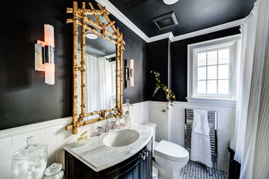 Elegant subway tile bathroom photo in Toronto with marble countertops and black walls
