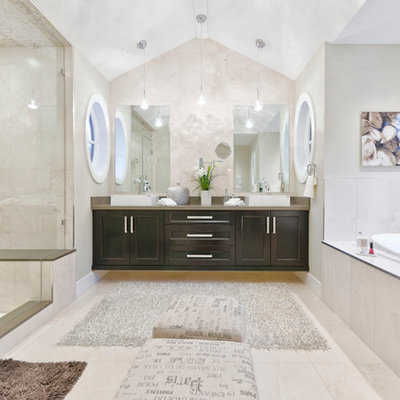 Example of a trendy beige tile bathroom design in Vancouver with a vessel sink, shaker cabinets and dark wood cabinets