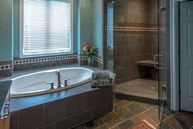 Bathroom - large eclectic master beige tile, blue tile, brown tile, gray tile, multicolored tile and cement tile travertine floor bathroom idea in Cincinnati with raised-panel cabinets, light wood cabinets, a one-piece toilet, green walls, an undermount sink and limestone countertops