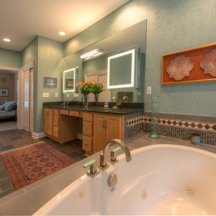 Large eclectic master beige tile, blue tile, brown tile, gray tile, multicolored tile and cement tile travertine floor alcove bathtub photo in Cincinnati with raised-panel cabinets, light wood cabinets, a one-piece toilet, green walls, an undermount sink and limestone countertops
