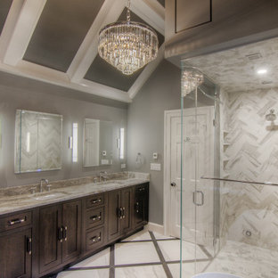 Inspiration for a large modern master multicolored tile and porcelain tile porcelain tile, multicolored floor, double-sink, coffered ceiling and wood wall bathroom remodel in Other with recessed-panel cabinets, brown cabinets, a one-piece toilet, gray walls, an undermount sink, a hinged shower door, multicolored countertops, a built-in vanity and quartzite countertops