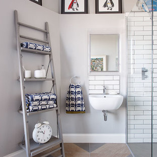 Contemporary bathroom in Other with a built-in shower, white tiles, metro tiles, grey walls, a wall-mounted sink and multi-coloured floors.