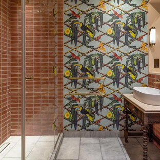 Photo of a medium sized eclectic ensuite bathroom in London with freestanding cabinets, dark wood cabinets, pink tiles, ceramic tiles, multi-coloured walls, marble flooring, a vessel sink, marble worktops, grey floors, a hinged door, an alcove shower and beige worktops.