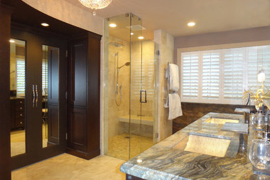 Inspiration for a transitional master beige tile and stone tile travertine floor corner shower remodel in San Francisco with an undermount sink, recessed-panel cabinets, dark wood cabinets, granite countertops, a one-piece toilet and multicolored walls