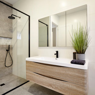 Inspiration for a beach style 3/4 bathroom in Melbourne with flat-panel cabinets, medium wood cabinets, an alcove shower, gray tile, cement tile, white walls, concrete floors, a console sink, grey floor and an open shower.