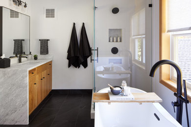 Photo of a modern bathroom in Minneapolis with flat-panel cabinets, light wood cabinets, marble worktops, white worktops, a single sink and a built in vanity unit.