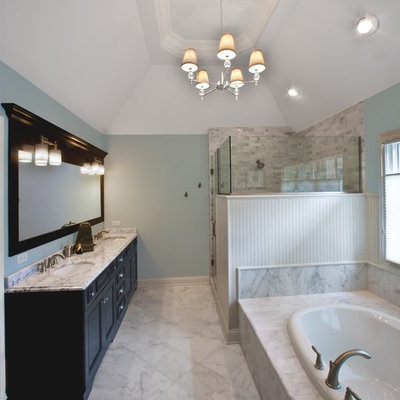 Bathroom - mid-sized traditional master marble tile marble floor bathroom idea in Chicago with recessed-panel cabinets, dark wood cabinets, blue walls, an undermount sink and marble countertops