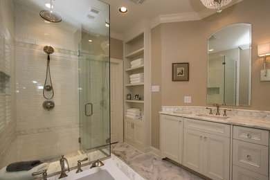 This is an example of a medium sized classic ensuite bathroom in New Orleans with a submerged sink, recessed-panel cabinets, white cabinets, marble worktops, a built-in bath, a walk-in shower, a one-piece toilet, white tiles, metro tiles and marble flooring.
