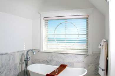Large beach style master gray floor freestanding bathtub photo in Philadelphia with recessed-panel cabinets, white cabinets, white walls and a hinged shower door