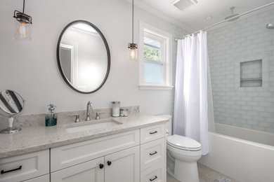 Inspiration for a mid-sized contemporary kids' alcove bathtub remodel in Vancouver with white cabinets, gray walls, quartzite countertops and gray countertops