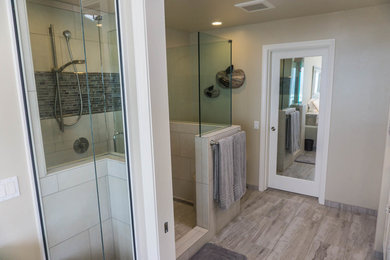 Inspiration for a mid-sized contemporary master beige tile and porcelain tile porcelain tile and beige floor bathroom remodel in San Diego with raised-panel cabinets, beige cabinets, a one-piece toilet, beige walls, an undermount sink and granite countertops