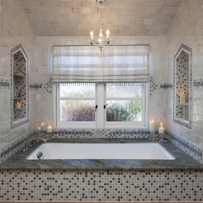 Corner shower - large traditional master multicolored tile and mosaic tile porcelain tile and beige floor corner shower idea in San Francisco with an undermount tub, raised-panel cabinets, dark wood cabinets, beige walls, an undermount sink, granite countertops, a hinged shower door and green countertops
