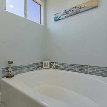 Coastal Master Bathroom with Built In Shower and Mosaic Tile Splash