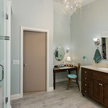 Oceanside Master Bathroom with Dark Vanity and Wall Sconces