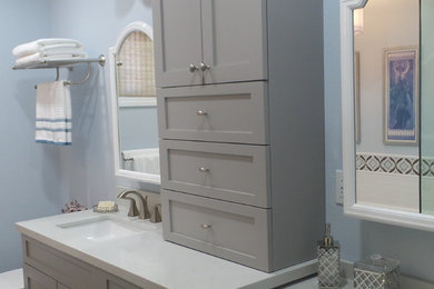 Example of a mid-sized transitional white tile and stone tile porcelain tile drop-in bathtub design in Los Angeles with shaker cabinets, gray cabinets, blue walls and quartz countertops