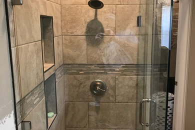 Example of a minimalist master corner shower design in Oklahoma City with a hinged shower door