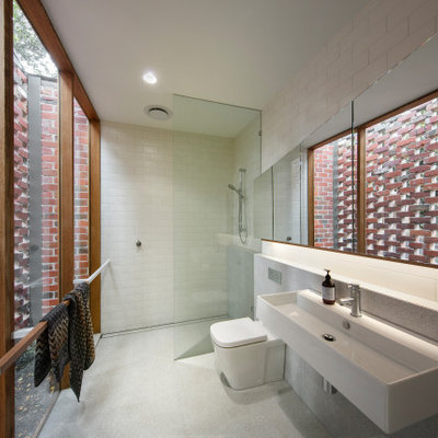 Inspiration for a small contemporary master white tile and ceramic tile ceramic tile and gray floor bathroom remodel in Melbourne with a one-piece toilet and a wall-mount sink