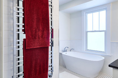 Inspiration for a transitional black and white tile and ceramic tile mosaic tile floor bathroom remodel in Toronto with flat-panel cabinets, white cabinets, a one-piece toilet, white walls, an undermount sink and granite countertops