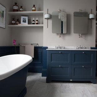 Inspiration for a medium sized classic ensuite bathroom in Essex with freestanding cabinets, blue cabinets, a freestanding bath, marble flooring, marble worktops, grey floors, grey worktops and a submerged sink.
