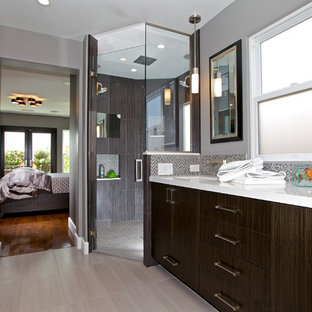 Walk-in shower - mid-sized contemporary master multicolored tile and mosaic tile porcelain tile and gray floor walk-in shower idea in San Diego with an undermount sink, flat-panel cabinets, solid surface countertops, dark wood cabinets, gray walls, a hinged shower door and white countertops