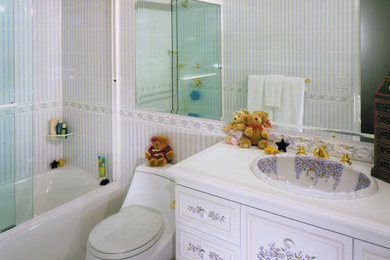 Mid-sized transitional kids' white tile and ceramic tile ceramic tile alcove bathtub photo in New York with a drop-in sink, furniture-like cabinets, distressed cabinets, quartz countertops and a one-piece toilet