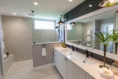 Walk-in shower - coastal gray tile and porcelain tile porcelain tile walk-in shower idea in Tampa with an undermount sink, shaker cabinets, gray cabinets, quartzite countertops, a two-piece toilet and gray walls