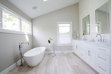 Mid-sized danish master white tile and ceramic tile marble floor and gray floor bathroom photo in Cleveland with white cabinets, a one-piece toilet, gray walls, an undermount sink, quartzite countertops, a hinged shower door and white countertops