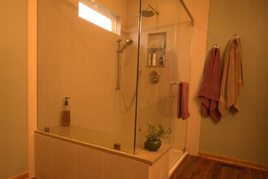 コロンバスにある中くらいなラスティックスタイルのおしゃれなマスターバスルーム (アンダーカウンター洗面器、クオーツストーンの洗面台、ベージュのタイル、磁器タイル、緑の壁、リノリウムの床) の写真
