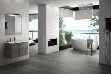 Example of a mid-sized trendy master white tile and stone tile porcelain tile bathroom design in Los Angeles with white walls, flat-panel cabinets, medium tone wood cabinets, a one-piece toilet, a drop-in sink and solid surface countertops
