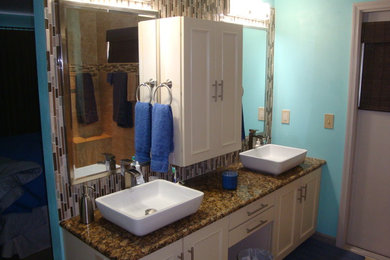 Inspiration for a mid-sized coastal master multicolored tile and matchstick tile bathroom remodel in Orlando with beaded inset cabinets, white cabinets, blue walls, a vessel sink and granite countertops