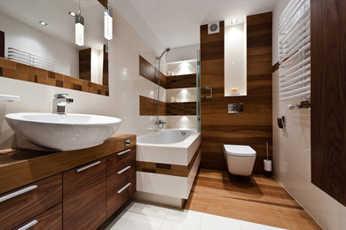Example of a mid-sized trendy master medium tone wood floor and brown floor bathroom design in Chicago with flat-panel cabinets, dark wood cabinets, a wall-mount toilet, beige walls, a vessel sink and a hinged shower door